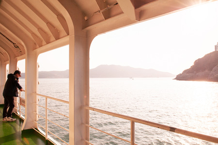 OCt 26, 2013 Yeosu, South Korea - Passenger enjoy evening light on upper deck of Yeosu harbor...