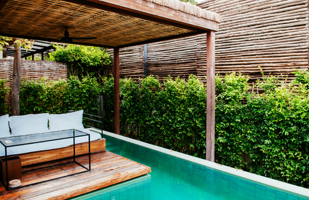 AUG 20, 2013 Hua Hin, THAILAND - Luxury tropical villa resort style infinity edge pool and daybed in...