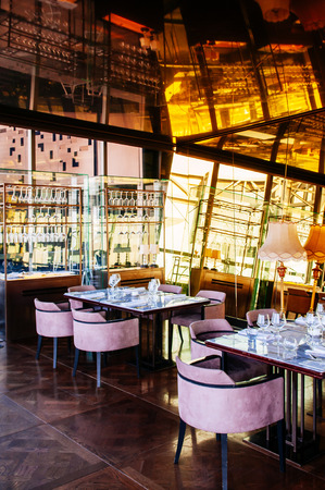 AUG 26, 2013 Bangkok, Thailand - Art deco interior diner room, vibrant desingn with mirror wall, color and luxury diner table set and armchairsのeditorial素材
