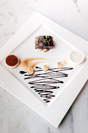 Fried Foie gras with sweet and sour balsamic sauce, pear sauce and cookieの写真素材