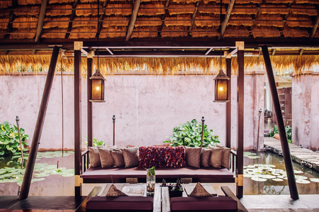 NOV 13, 2013 Samui, Thailand - Tropical Resort living room with wooden furniture, tropical style interior luxury decoration with colourful pillows and fabricのeditorial素材