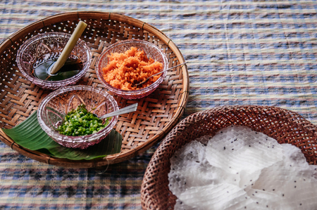 Khao Kriab Yana local snack of Ban Nam Chiao, Trat, Thailand Street food crispy rice snack with shredded coconut, shrimp and sugar cane syrupの写真素材