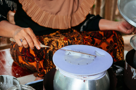 Making Khao Kriab Yana local snack of Ban Nam Chiao, Trat, Thailand Street food steam rice flour on top of hot water potの写真素材