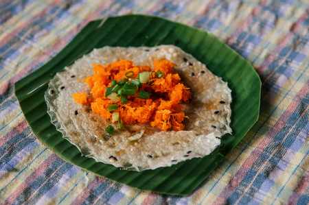 Khao Kriab Yana local snack of Ban Nam Chiao, Trat, Thailand Street food crispy rice snack with shredded coconut, shrimp and sugar cane syrupの写真素材