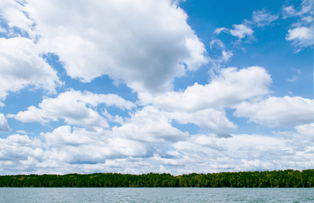 Skyscape blue summer sky with white clouds and tropical green lush mangrove forest in Trat, Thailandの写真素材