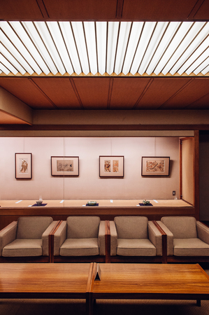 MAY 25, 2013 Gifu, JAPAN - Classic vintage Japanese living room wood table and retro design armchairs. Warm light and atmosphere from ceiling lampのeditorial素材