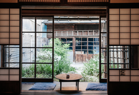 MAY 26, 2013 Gifu, JAPAN - Old Japanese houses interior with sliding door, indego fabric cusion and wood table. Famous warm atmosphere Melon bun shop cafe of Hida Furukawa town old historic town.のeditorial素材