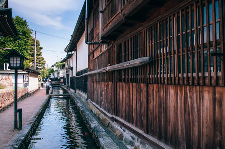 MAY 26, 2013 Gifu, JAPAN - Old traditional wooden houses and Japanese tourist on street and small natural stream of Hida Furukawa town old historic town.のeditorial素材