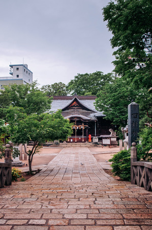 Stone road to Yohashira shrine famous historic tourist spot on Nawate street of Matsumoto city, Nagano - Japan. Kanji letter written on concrete pillar is name ofのeditorial素材