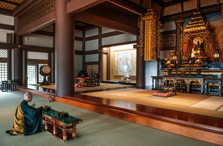 MAY 30, 2013 Nagoya, JAPAN - Japanese monk praying in hall of old  Thai Syakamuni Buddha statue was sent to Japan as a gift by King Chulalongkorn or King Rama V of Siam (Thailand)  symbol of friendship between two countriesのeditorial素材