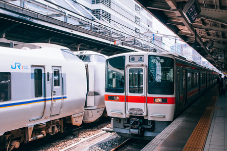 MAY 30, 2013 Nagoya, Japan - Gifu train line stop at platform of JR Chuo Main line at Nagoya station with Japanese passengers walking behind yellow lineのeditorial素材