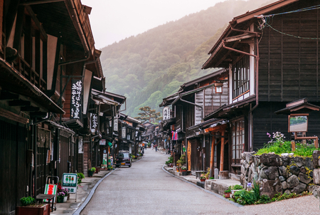 MAY 29, 2013 Nagano, Japan - Old wooden house and narrow street of Narai Post town (Narai-Juku) the midpoint town on Nakasendo road, Edo period trading route between old Tokyo and Kyotoのeditorial素材