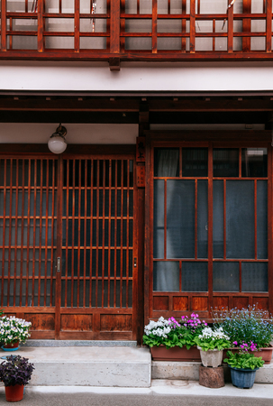 MAY 29, 2013 Nagano, Japan - Beautiful flower plant pots in front of old house in Narai Post town (Narai-Juku). The midpoint town on Nakasendo road, Edo period trading route between old Tokyo and Kyotoのeditorial素材