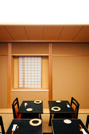 MAY 26, 2013 Gifu, JAPAN - Japanese houses interior with sliding door and black wood dinner table. Warm atmosphere with light yellow painted wall, Tatami floorのeditorial素材