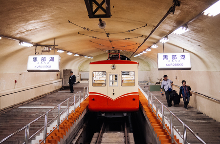 MAY 28, 2013 Toyama, Japan - Passenger and station officer at Korobeko tunnel with Kurobe Cable Car...