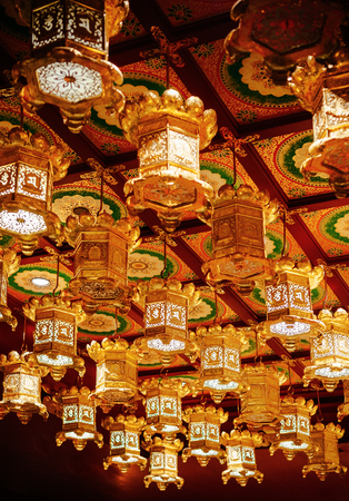 DEC 18, 2013 Singapore - Golden lanterns haging from ceiling at Singapore Buddha Tooth relics temple  with Chinese Tang dynasty Architecture style in Chinatownのeditorial素材