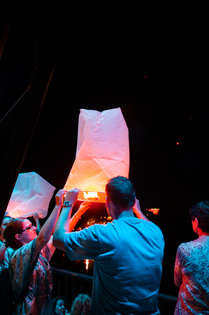 NOV 17, 2013 Chiang Mai, Thailand - Tourists  holding and enjoy releasing Lanna style Yi Peng floating lanterns in Loy Krathong festival of Chiang Mai provinceのeditorial素材