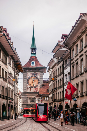 SEP 28, 2013 Bern, Switzerland - Old vintage street scene with tourists and tram running in front of astronomical Zytglogge clock tower. Famous old town area and shopping streetのeditorial素材