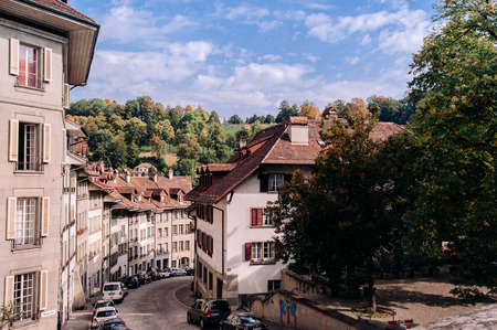 SEP 27, 2103 Bern, Switzerland - Old curvy hill Junkerngasse street with cars and old Swiss style residential buildings in Old town district of Bernのeditorial素材