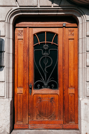 SEP 26, 2013 Neuchatel, Switzerland - Classic old vintage wooden door of old building in La Chaux de Fonds, the most important centre of the Swiss watch making industryの写真素材
