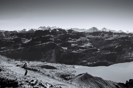 Lake Brienz and Schwarzhorn Swiss Alps and tourist on hiking trail on top of Brienzer Rothornの写真素材