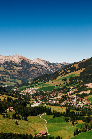 Green hills valley Sorenberg town at foot of mount Brienzer Rothorn with mount Schrattenfluh in background. Switzerlandの写真素材