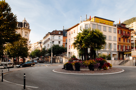 SEP 25, 2013 Montreux, Switzerland -  Light traffic street and roundabout with garden in Montreux city center with beautiful building in backgroundのeditorial素材
