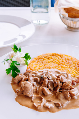 Zurich style veal meat stew with creamy mushroom gravy sauce and fried rosti potato, Local Swiss cuisine in white plateの写真素材