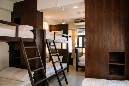 FEB 12, Chiang Mai, THAILAND - Hostel dormitory bunk beds arranged in room, backpacker hostel furnished with wooden dormitory style bunk beds and whit clean linens.のeditorial素材