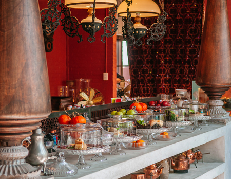 FEB 12, 2014 Chiang Mai, THAILAND - Pastry bar and assorted puff pastries, fruits on luxurious glass pedestal tray in vintage decor bakery cafeのeditorial素材