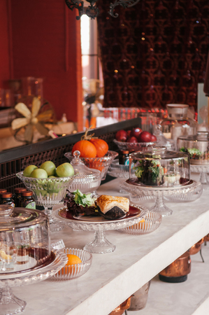 FEB 12, 2014 Chiang Mai, THAILAND - Pastry bar and assorted puff pastries, fruits on luxurious glass pedestal tray in vintage decor bakery cafeのeditorial素材