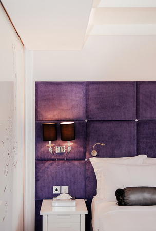 MAR 13, 2014 Bangkok, THAILAND - Vintage luxury interior hotel room, bed and well design lamp, side table. Vintage sweet luxury home decorating design natural lightのeditorial素材