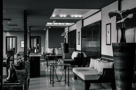 AUG 6, 2014 Hua Hin, THAILAND - Asian tropical style hotel lobby with contemporary furnitures, wooden couch, table and elegance decorating items. Black and White imageのeditorial素材