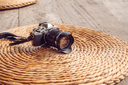 Front view old vintage retro style camera on dried water hyacinth mat natural texture background with copy space. Photographer lifestyle image conceptの写真素材