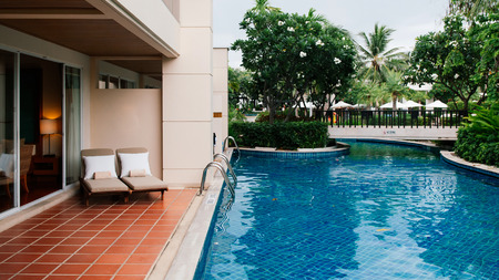 AUG 7, 2014 Hua Hin, THAILAND - Tropical resort pool beds at outdoor balcony by swimming pool in the gardenのeditorial素材