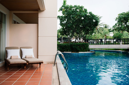 AUG 7, 2014 Hua Hin, THAILAND - Tropical resort pool beds at outdoor balcony by swimming pool in the gardenのeditorial素材