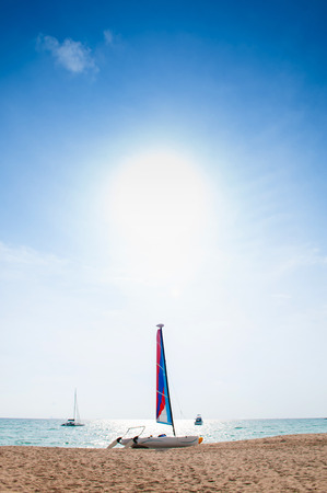Summer at Bakantiang beach with sailboat against sun in Koh Lanta  with clear blue sky - Krabi, Thailandの写真素材