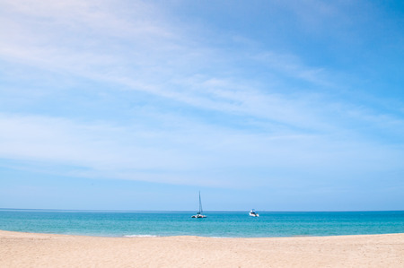 Summer at Bakantiang beach. European tourist on white sand beach with clear blue skyの写真素材