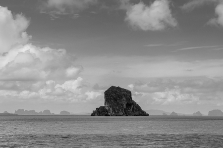 Small rock island near Koh Lanta, Krabi on clear blue sky day, calm Andaman sea in Thailand - Black and whiteの写真素材