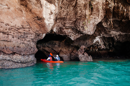 MAY 21, 2014 Koh Lanta, Krabi, Thailand - Kayak excursion in sea cave with blue turqouise water. Tourists exploring sea cave of Koh Talabeng.のeditorial素材