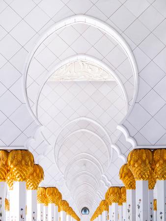 FEB 2, 2015 Abu Dhabi, UAE - White marble arch gates corridor with golden palm pillars of Sheikh Zayed Mosque, Grand mosque white marble architecture perspectiveのeditorial素材