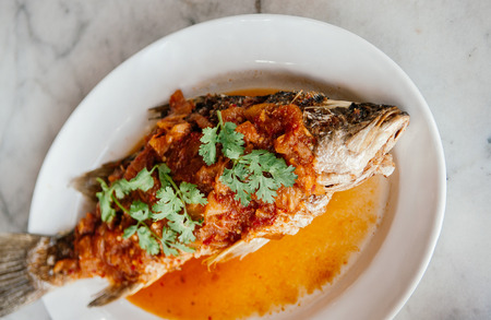Deep Fried Fish with sweet and sour chili Sauce (Pla Rad Prik) top with cilantro Coriander - Thai...