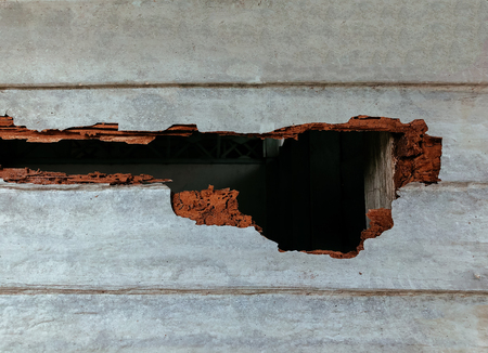 Damaged wood wall by Termites with big hole - House stucture with serious termite problem - ruined old wood wallの写真素材