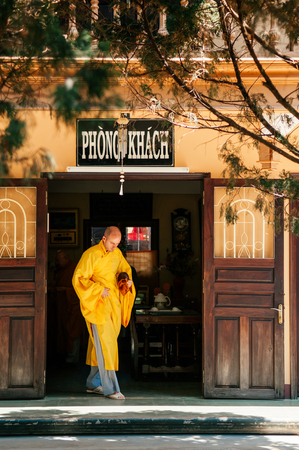 FEB 26, 2014 Dalat, Vietnam - Monk in yellow robe at Truc Lam Da Lat Zen Monastery - Vietnamese buddhist temple. Most famous monastery near lake Tuyen Lamのeditorial素材