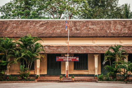 APR 4, 2019 Luang Prabang, Laos - Yellow old classic French Colonial building of elementary school with green door and windows in Luang Prabang - Laosのeditorial素材
