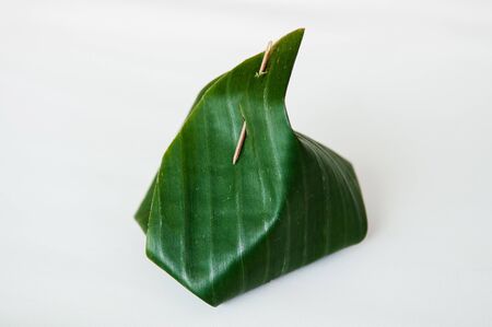 Traditional Thai banana leaf wrapped dessert isolated on white - Environmaental friendly food...