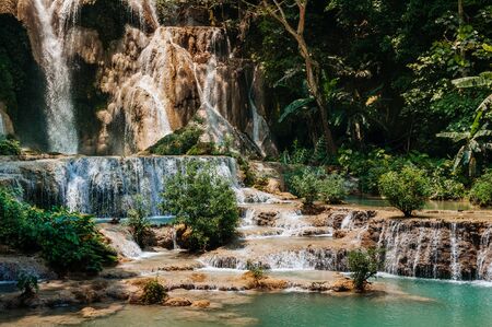 Blue turquoise water pond Kuang Si waterfall among rain forest in Luang Prabang, Laos during summer season.の写真素材