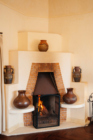 FEB 25, 2014 Dalat, Vietnam - Vintage retro old brick fireplace wooden chairs and lamp in hard wood floor living room in French colonial houseのeditorial素材