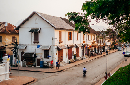 APR 4, 2019 Luang Prabang, Laos - French Colonial building along Luang Prabang main street with tourist and local people under warm morning lightのeditorial素材