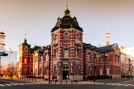 DEC 2, 2018 Iwate, Japan - Red brick building classic old Bank of Iwate in Morioka city at evening with sunset light. Iconic land mark with people walking on street - Tohoku region beautiful landscape and cityのeditorial素材